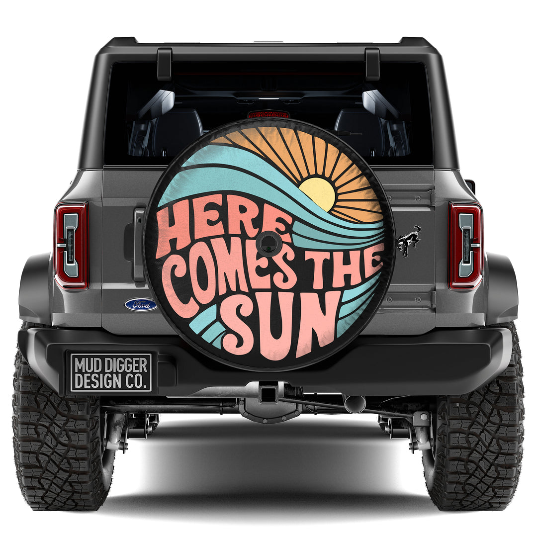 Ford Bronco 'Here Comes the Sun' Tire Cover – Custom-fit, weatherproof spare tire cover with a vibrant sun design. UV-resistant and durable for all terrains.