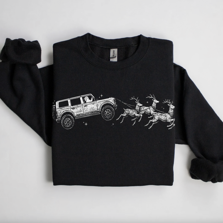 Santa’s Bronco Sleigh Crewneck Sweatshirt – Black Christmas sweatshirt with white Bronco and reindeer design, holiday apparel by Mud Digger Design Co.