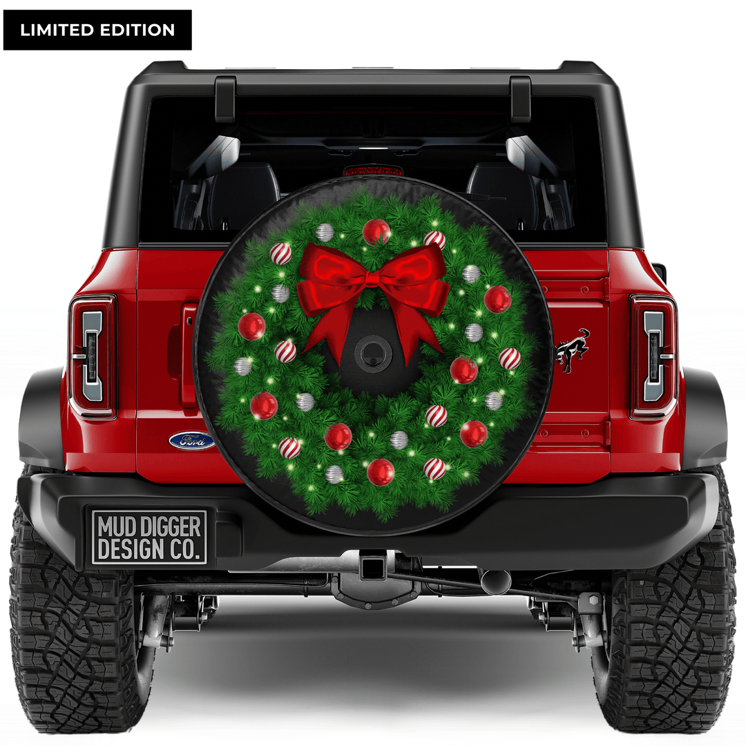 Ford Bronco Christmas wreath tire cover with festive holiday design, featuring a detailed wreath and perfect fit for Bronco models. Weatherproof and durable for year-round protection.