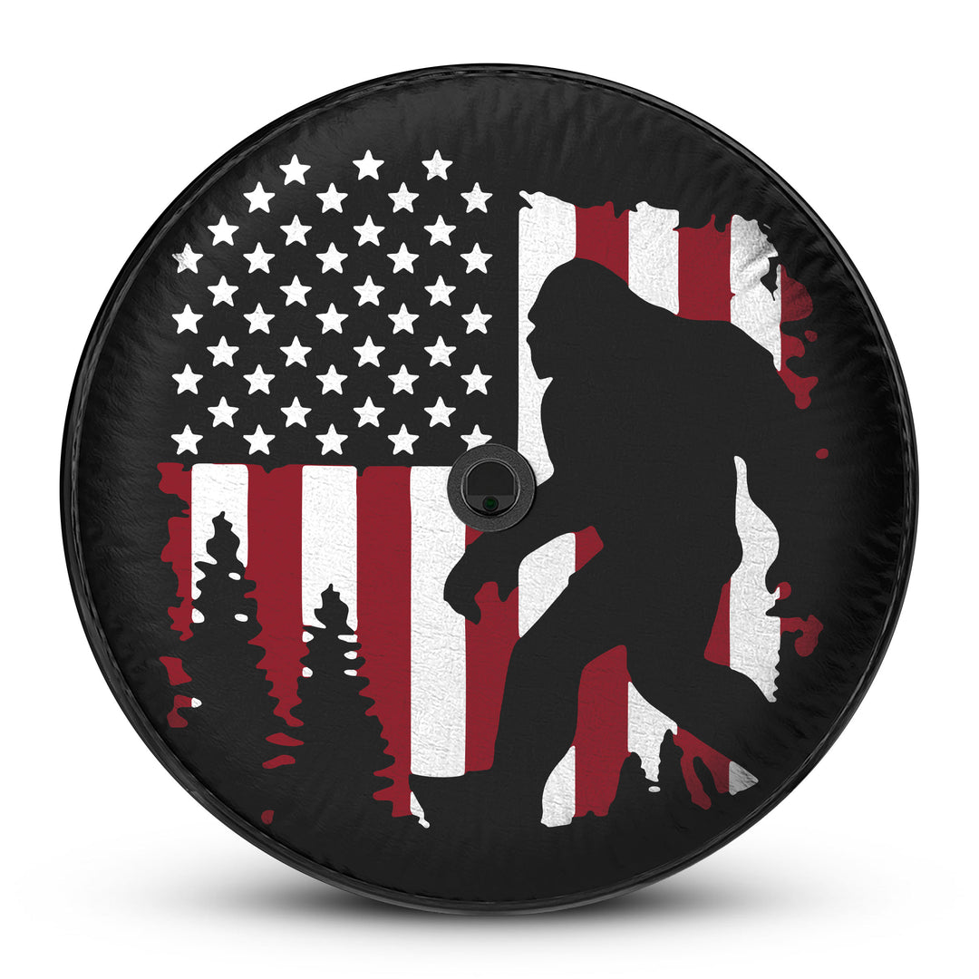 Ford Bronco Sasquatch Flag Tire Cover featuring a rugged design with an American flag and Sasquatch silhouette, perfect for off-road enthusiasts and adventure seekers. Durable, weather-resistant, and custom-fit for your Bronco