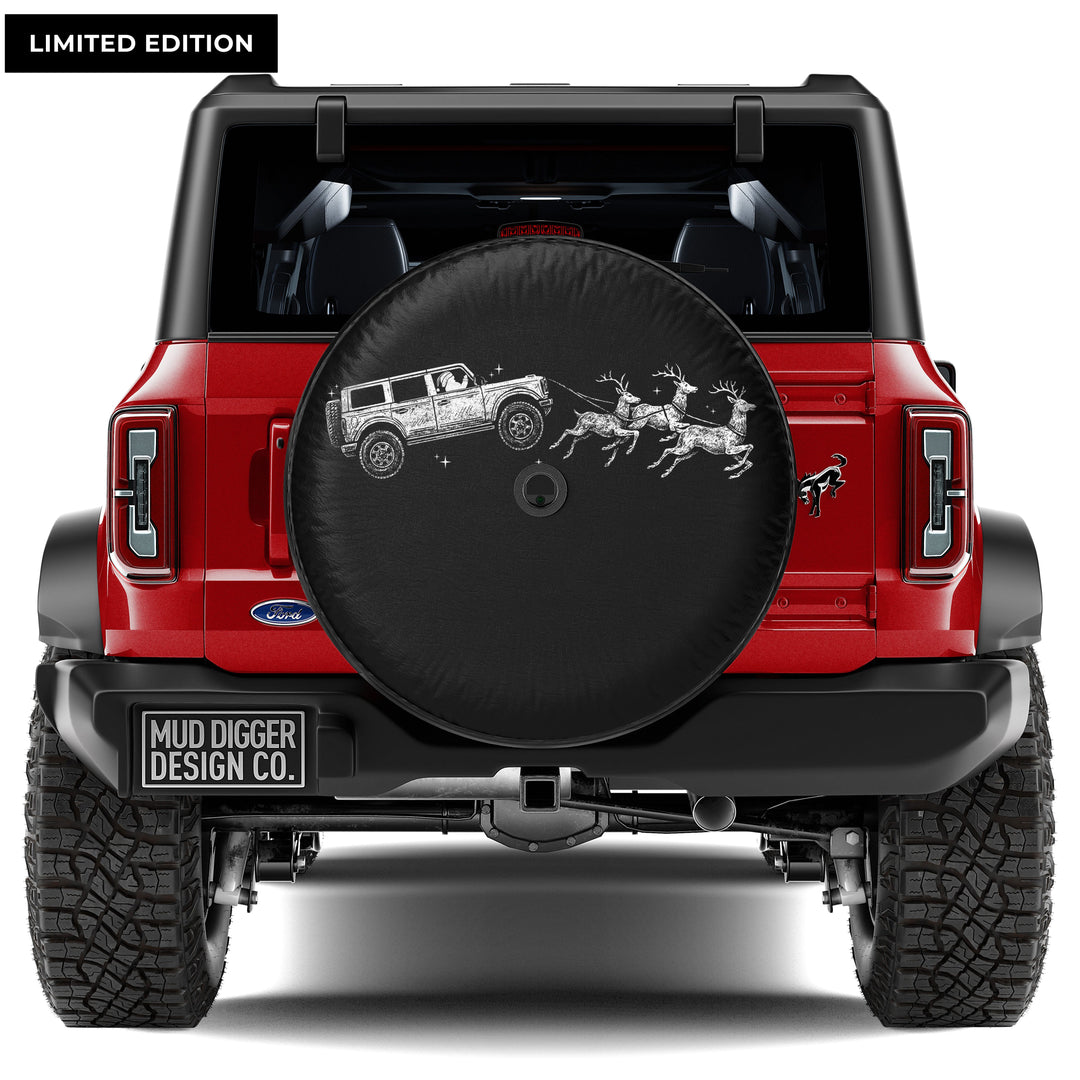 Santa driving a Ford Bronco pulling reindeer, Christmas-themed spare tire cover for Ford Bronco